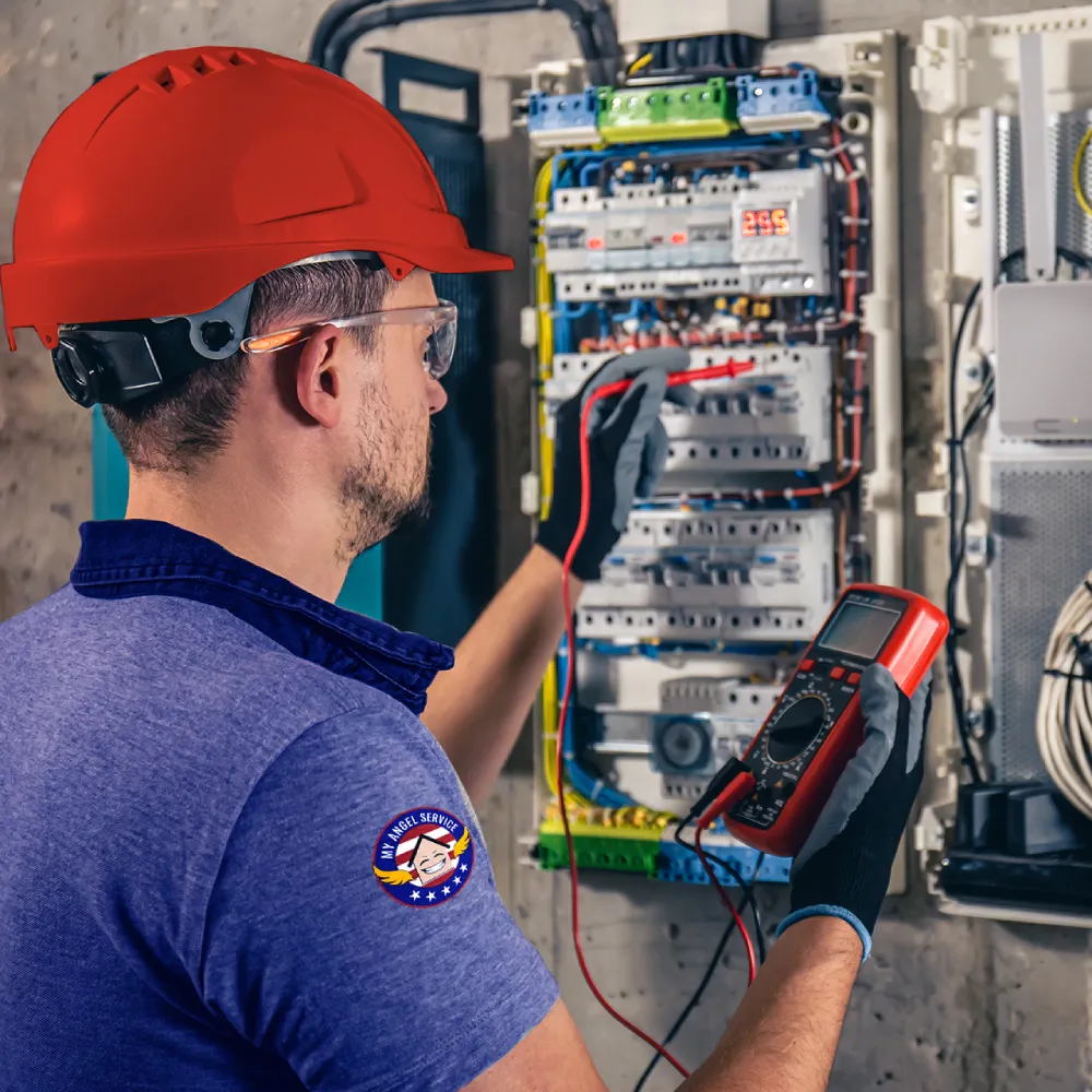 Electrical technician working on a switch panel.