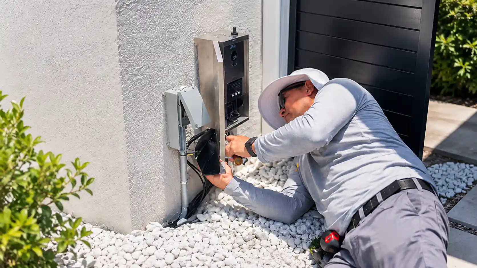 electrician servicing an outdoor EV charger during an electrical capacity upgrade