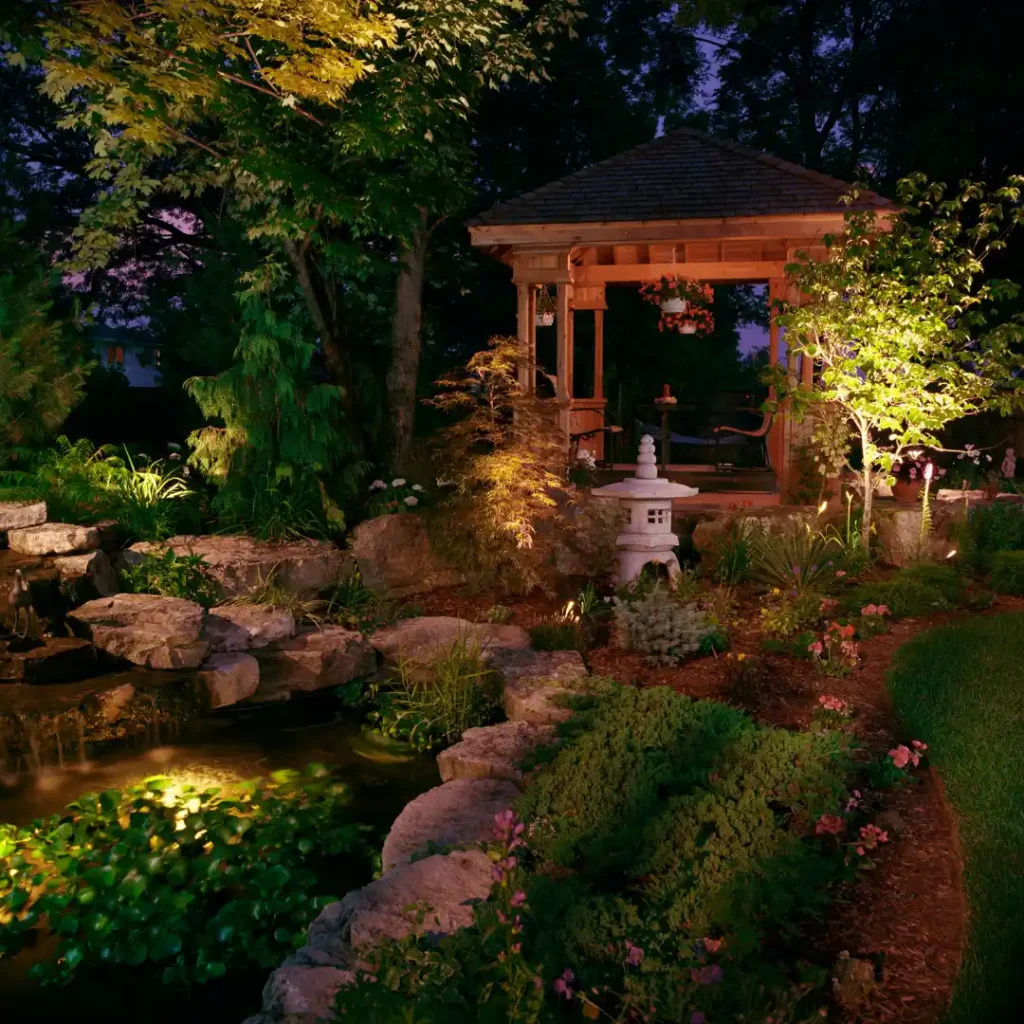 Landscaped garden illuminated with professionally installed outdoor landscape lighting